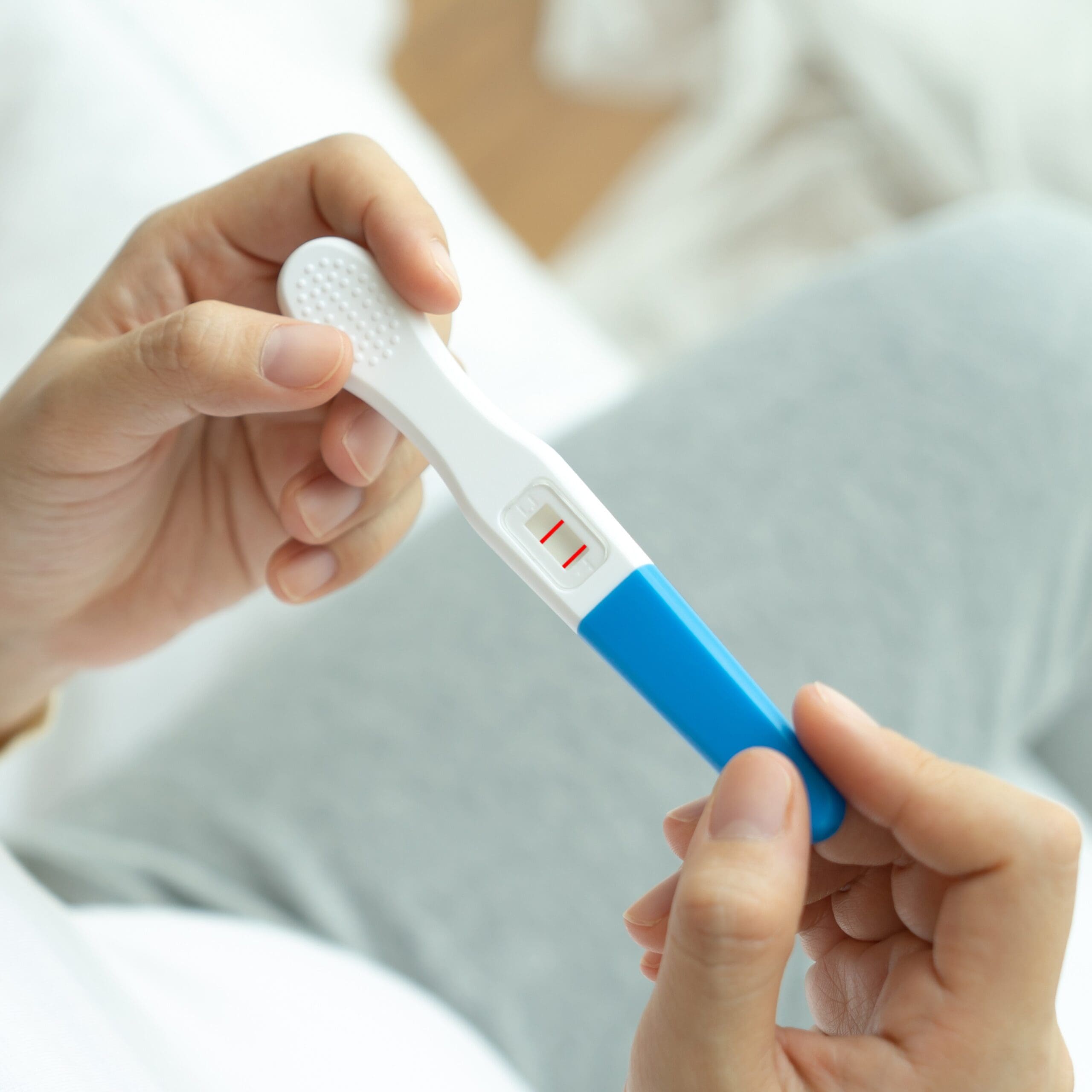 A woman holding a free pregnancy test in Fresno, California
